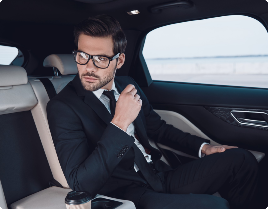 Business passenger riding in the back seat of a limo from Arleta