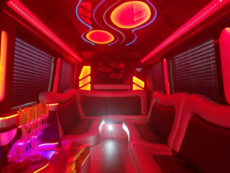 Mercedes Sprinter party interior with red lighting and bar