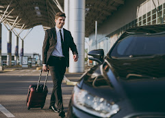 Business traveler with suitcase at the airport, North Hills