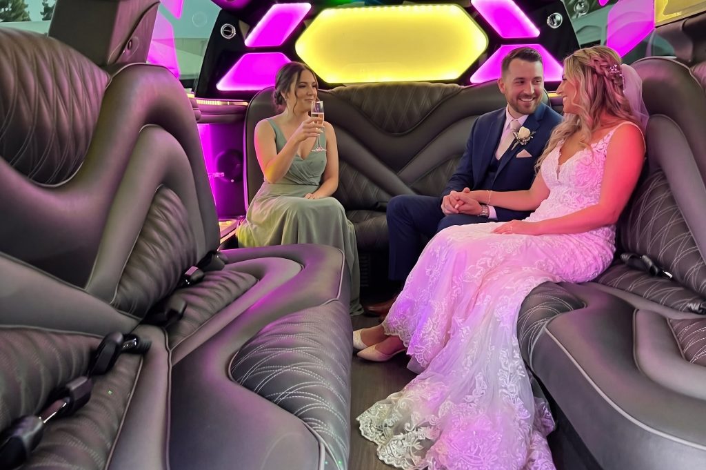 Bride and groom relaxing inside a limousine