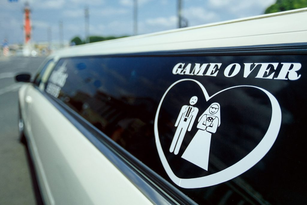 Wedding limousine decorated with a playful just married sign